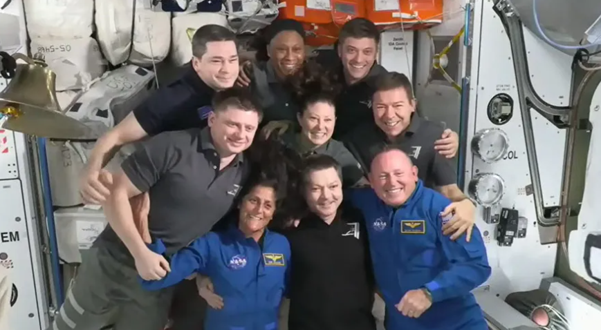 The seven Expedition 71 crew members gather with the two Crew Flight Test members for a team portrait aboard the space station. In the front from left are, Suni Williams, Oleg Kononenko, and Butch Wilmore. Second row from left are, Alexander Grebenkin, Tracy C. Dyson, and Mike Barratt. In the back are, Nikolai Chub, Jeanette Epps, and Matthew Dominick. Credit: NASA TV
